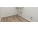 Empty laundry room features wood-look vinyl flooring and utility hookups at 11934 W Parkway Ln, Avondale, AZ 85323