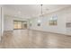 Spacious living area featuring wood-look floors, ample natural light, and sliding glass doors to the patio at 11934 W Parkway Ln, Avondale, AZ 85323