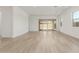 Bright living room with wood-look floors, natural light, and easy access to the outdoor living space at 11934 W Parkway Ln, Avondale, AZ 85323