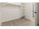 Spacious walk-in closet with carpet flooring, rod and shelving perfect for organized storage at 11934 W Parkway Ln, Avondale, AZ 85323