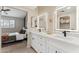 Bathroom featuring a double sink vanity with modern mirrors and access to the main bedroom at 3059 E Rose Ln, Phoenix, AZ 85016