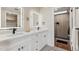 Bathroom with a double sink vanity, modern mirrors and fixtures, and a glass-enclosed shower at 3059 E Rose Ln, Phoenix, AZ 85016