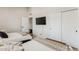 Bright bedroom with dual beds, television, and closet space at 3059 E Rose Ln, Phoenix, AZ 85016