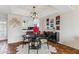 Dining area with modern lighting, a black table, and an adjacent kitchen at 3059 E Rose Ln, Phoenix, AZ 85016