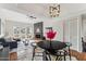 Open-concept dining room next to the living room featuring a modern light fixture at 3059 E Rose Ln, Phoenix, AZ 85016