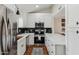 Modern kitchen featuring white cabinets, stainless steel appliances, and stylish backsplash at 3059 E Rose Ln, Phoenix, AZ 85016