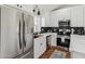 Modern kitchen featuring stainless steel appliances and stylish white cabinets at 3059 E Rose Ln, Phoenix, AZ 85016