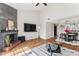 Open living room featuring a stone fireplace, tile floors, and modern furnishings at 3059 E Rose Ln, Phoenix, AZ 85016