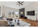 Cozy living room with fireplace, ceiling fan, and access to a private balcony at 3059 E Rose Ln, Phoenix, AZ 85016