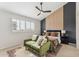 Stylish main bedroom with accent wall, ceiling fan and relaxing green sofa at 3059 E Rose Ln, Phoenix, AZ 85016