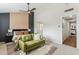 Bright main bedroom with view to ensuite, accent wall and loveseat at 3059 E Rose Ln, Phoenix, AZ 85016