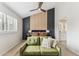 Comfortable main bedroom with accent wall, ceiling fan, and green loveseat at 3059 E Rose Ln, Phoenix, AZ 85016