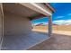 A covered back patio for entertaining with a concrete floor and views of the backyard at 11950 W Parkway Ln, Avondale, AZ 85323