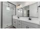 A modern bathroom with a double vanity and a frameless glass shower at 11950 W Parkway Ln, Avondale, AZ 85323