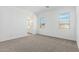 A cozy bedroom with two large windows and an ensuite bathroom at 11950 W Parkway Ln, Avondale, AZ 85323