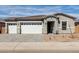 Charming single-story home with a three-car garage, brick accents, and a well-maintained front yard at 11950 W Parkway Ln, Avondale, AZ 85323