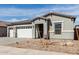 Charming single-story home with a convenient three car garage and tidy landscaping at 11950 W Parkway Ln, Avondale, AZ 85323