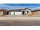 Charming single-story home with a three car garage, a well-manicured yard, and inviting curb appeal at 11950 W Parkway Ln, Avondale, AZ 85323