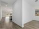 Hallway area with luxury vinyl plank flooring, leading into an open-concept kitchen and living space at 11950 W Parkway Ln, Avondale, AZ 85323