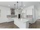 Bright kitchen boasts a center island with pendant lights, stainless steel appliances, and ample counter space at 11950 W Parkway Ln, Avondale, AZ 85323