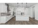 Modern kitchen features white cabinetry, stainless steel appliances, a stylish backsplash, and a large center island at 11950 W Parkway Ln, Avondale, AZ 85323