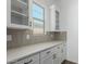 Beautiful kitchen with white cabinets, light countertops, stylish backsplash, and a window for natural light at 11950 W Parkway Ln, Avondale, AZ 85323