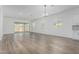 Spacious living room with ample natural light, vinyl floors, and a sliding glass door leading to the outside at 11950 W Parkway Ln, Avondale, AZ 85323