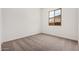 An inviting bedroom offers plush carpeting and a window for natural light at 12007 W Parkway Ln, Avondale, AZ 85323