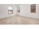 A bright bedroom features tile flooring and three windows offering great natural light at 12007 W Parkway Ln, Avondale, AZ 85323