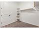 A walk-in closet featuring built-in shelves and ample storage space at 12007 W Parkway Ln, Avondale, AZ 85323