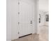Inviting white front door leads to a bright, open entryway with tile flooring at 12007 W Parkway Ln, Avondale, AZ 85323