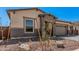 Charming front exterior with desert landscaping, stone accents and a welcoming entrance at 12007 W Parkway Ln, Avondale, AZ 85323