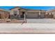 Attractive front exterior with a three-car garage and stylish brick-paved driveway at 12007 W Parkway Ln, Avondale, AZ 85323