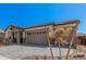 Beautiful front exterior featuring a three-car garage and patterned brick driveway at 12007 W Parkway Ln, Avondale, AZ 85323