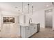 Bright and airy kitchen with white cabinets and a large center island at 12007 W Parkway Ln, Avondale, AZ 85323