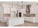 Modern kitchen with white cabinets, stainless steel appliances, a center island, and stylish pendant lighting at 12007 W Parkway Ln, Avondale, AZ 85323