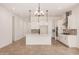Well-lit kitchen with white cabinets, modern appliances, an island, and ample counter space at 12007 W Parkway Ln, Avondale, AZ 85323