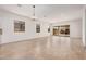 A large living room with recessed lights, chandelier, and sliding glass doors at 12007 W Parkway Ln, Avondale, AZ 85323