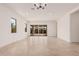 A bright living room has recessed lights, large sliding glass doors, and tile flooring at 12007 W Parkway Ln, Avondale, AZ 85323