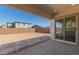 View of the backyard and covered patio with a view of surrounding homes at 12012 W Parkway Ln, Avondale, AZ 85323