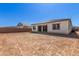 The home's backyard with view of the covered patio and the neighbor's homes at 12012 W Parkway Ln, Avondale, AZ 85323