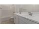 Well-lit bathroom features a double vanity, white cabinets, and a shower-tub combo at 12012 W Parkway Ln, Avondale, AZ 85323