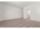 Large bedroom with plush neutral carpet, white walls, and ensuite bathroom at 12012 W Parkway Ln, Avondale, AZ 85323