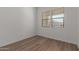 Bedroom with wood-style floors, light-colored walls, and a double window at 12012 W Parkway Ln, Avondale, AZ 85323