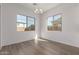 Bright, airy dining room featuring light wood floors, large windows, and ample natural light at 12012 W Parkway Ln, Avondale, AZ 85323