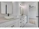 Bright bathroom featuring double sinks, marble countertops, and modern fixtures with access to another room at 32278 N 168Th Ave, Surprise, AZ 85387
