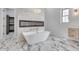 Modern bathroom boasts soaking tub, fireplace, marble flooring and dual vanities at 32278 N 168Th Ave, Surprise, AZ 85387