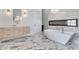 Spa-like bathroom with a soaking tub, fireplace, modern vanity, and stylish marble flooring at 32278 N 168Th Ave, Surprise, AZ 85387