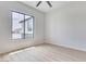 Neutral bedroom with a ceiling fan and a large window at 32278 N 168Th Ave, Surprise, AZ 85387