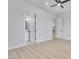 Spacious bedroom with neutral walls, laminate flooring, ceiling fan, and access to a bathroom and closet at 32278 N 168Th Ave, Surprise, AZ 85387